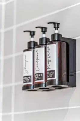 three bottles ofodorizers sitting on a bathroom mirror at Stylish 2BR Urban Escape, BBQ, Private Terrace in Toronto
