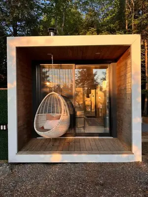 a small house with a hammock in a window at Aux Box Muskoka Modern Muskoka Bunkie in Huntsville