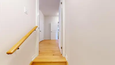 a hallway with a stairway leading into a room at New Custom-built House Close to Rogers Stadium in Toronto
