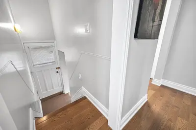 an empty hallway with a white wall and a window at Modern 5BR Home with Office and Parking and WiFi in Oakville