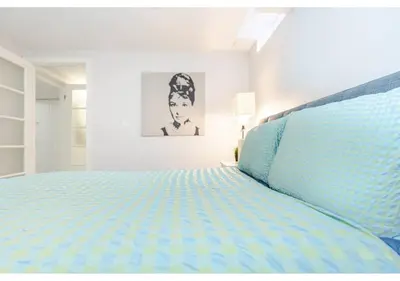 a bedroom with a large bed with blue sheets at 2 bedroom apartment-2 free parking -14 min to Pearson airport in Mississauga