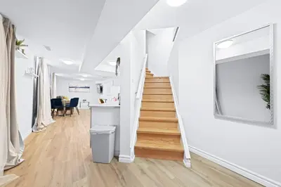 a white staircase in a white room with a stair case at Charming 1-bed basement, Wi-Fi in Barrie