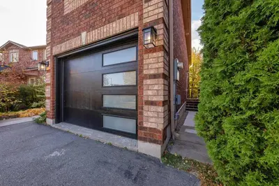 a garage door on the side of a brick building at Charming 1-bed basement, Wi-Fi in Barrie