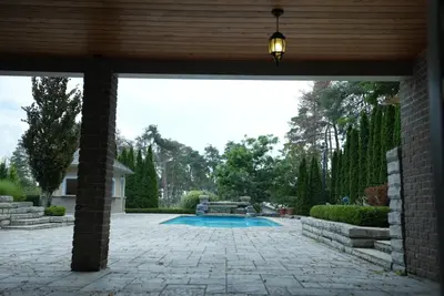 a patio with a swimming pool in a yard at Chez Mason in Richmond Hill