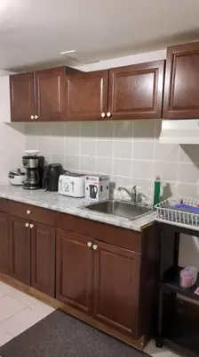 a kitchen with wooden cabinets and a sink at Whole House Fair Price Great Amenities in Richmond Hill