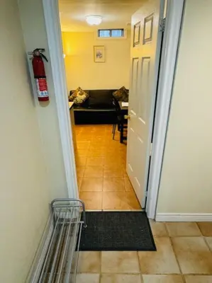 a hallway leading to a living room with a fire hydrant at Sunnys Home Stays 1 Bedroom Bath & Kitchenette Toronto Mississauga At Erin Mills With Pvt Entrance in Mississauga