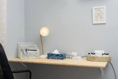 a desk with a lamp and other items on it at Private Cozy Room with Free Parking in Toronto