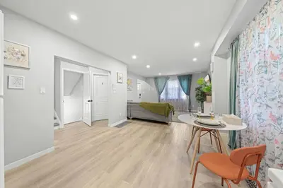 a living room with a table and a couch at Private Cozy Room with Free Parking in Toronto