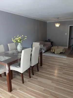 a dining room with a table and white chairs at Multiple Fair Price Great Amenities Rooms in Richmond Hill