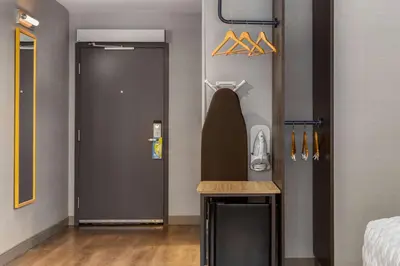 a room with a bathroom with a sink and a door at Tru By Hilton Bracebridge, On in Bracebridge