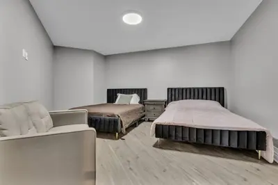 a bedroom with two beds and a couch at Private Farmhouse Getaway with hot tub in Waterloo