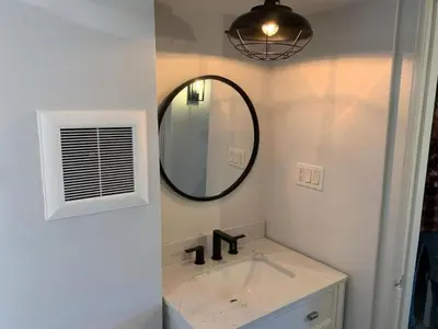 a bathroom with a sink and a mirror at County Cove - Picton Suite - downtown Wellington in Wellington