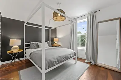 a bedroom with a white canopy bed and a window at 4 Bedroom Luxury House, Free Parking, Next to LRT, Kitchener Downtown, near Chicopee Ski Club in Kitchener