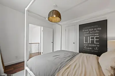 a bedroom with a bed with a poster on the wall at 4 Bedroom Luxury House, Free Parking, Next to LRT, Kitchener Downtown, near Chicopee Ski Club in Kitchener