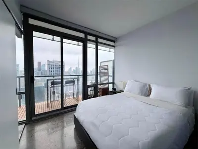 a bedroom with a white bed and a large window at 44th Floor, Panoramic Views, Bay Corridor Downtown Toronto Condo in Toronto