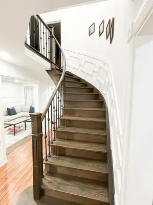 a spiral staircase in a home with a white wall at Supreme Suites in Ajax