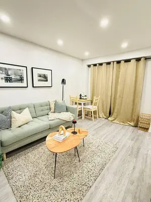a living room with a couch and a table at Cozy private backyard garden studio in Pickering