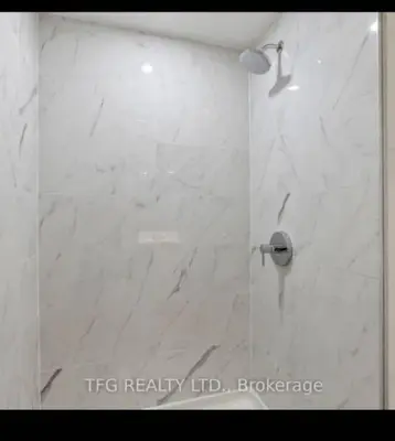 a bathroom with a shower with a white marble at One-Bedroom Basement in Oshawa