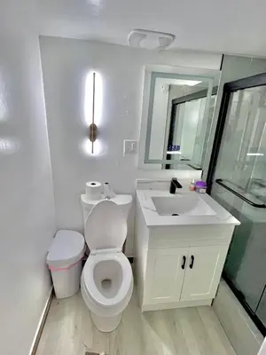 a white bathroom with a toilet and a sink at Private Room Near Airport D7 in Brampton