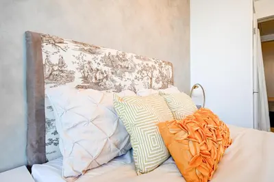 a pile of pillows sitting on top of a bed at The Urban Escape in Toronto