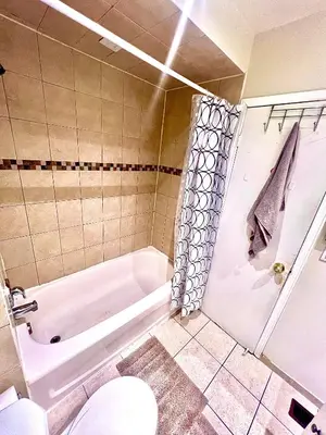 a bathroom with a tub and a toilet and a sink at Private Room Near Airport D6 in Brampton