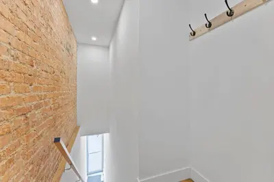 a brick wall in a room with a window at Chic 2BR Top Floor Retreat with Rooftop Near Subway in Toronto