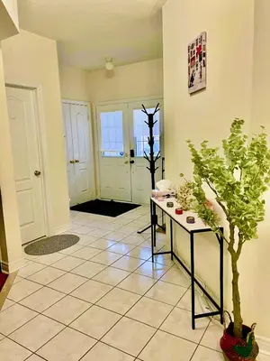 a living room with a table and a potted plant at Extended Stays Home in Markham