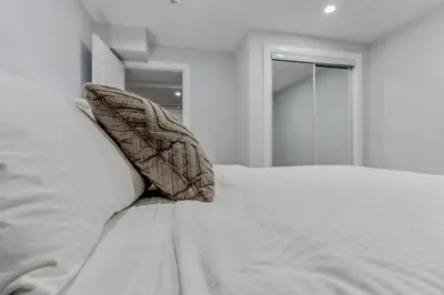 a white bed with two pillows on top of it at Luxurious Unit in Hyde Park in London