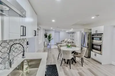 a kitchen and living room with a table and chairs at Luxurious Unit in Hyde Park in London