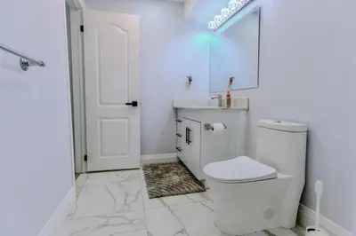 a white bathroom with a toilet and a shower at Luxurious Unit in Hyde Park in London