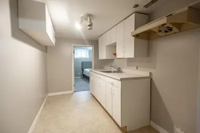a kitchen with white cabinets and a sink at Charming 4BR Barrie Retreat with Backyard in Barrie
