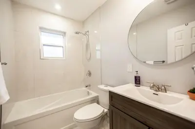 a bathroom with a tub and a toilet and a sink at Charming 4BR Barrie Retreat with Backyard in Barrie