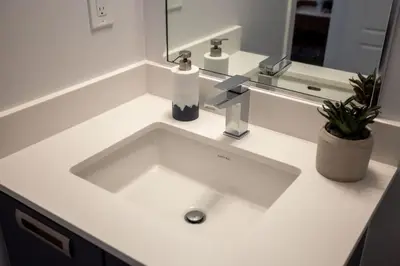 a white sink in a bathroom with a mirror at Amazing 2BR 2BA Resort Condo w Balcony and Parking in Barrie