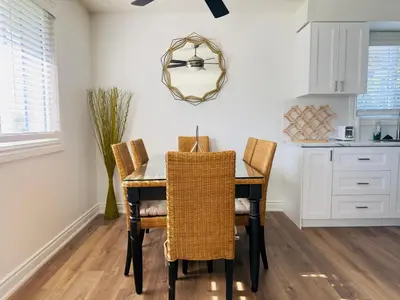 a dining room table with chairs and a mirror at Lovely Beachside Oasis 2BD in Port Dover in Port Dover