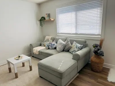 a living room with a couch and a table at Lovely Beachside Oasis 2BD in Port Dover in Port Dover