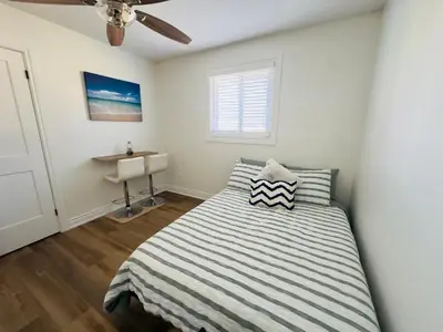 a bedroom with a bed and a window and a sink at Lovely Beachside Oasis 2BD in Port Dover in Port Dover
