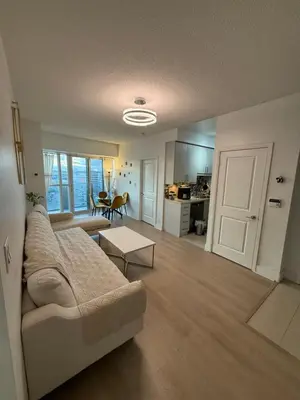 a living room with a couch and a table at 2 Bedroom 1 Bathroom renovated fully furnished apartment in Mississauga
