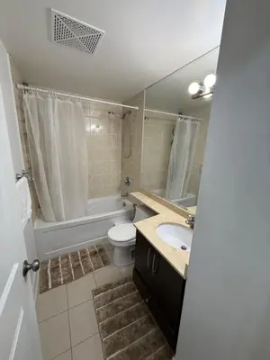 a bathroom with a toilet and a sink and a tub at 2 Bedroom 1 Bathroom renovated fully furnished apartment in Mississauga