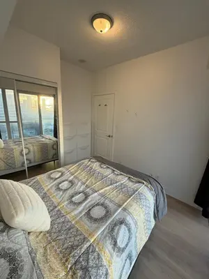 a bedroom with a bed with a quilt on it at 2 Bedroom 1 Bathroom renovated fully furnished apartment in Mississauga