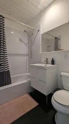a white bathroom with a sink and a toilet at Stunning Victorian in Downtown in Toronto