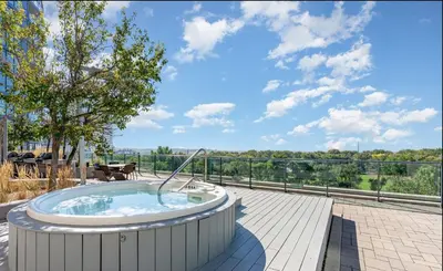 a jacuzzi tub on a patio at Luxury Downtown Condo with CN tower views, Pool Access, Gym,Free Parking upon request at booking, accommodates 4 in Toronto