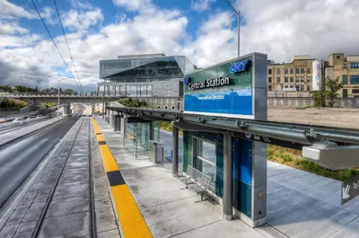 a train station in a city with a building at Entire 1 bedroom in the heart of KW downtown across Google in Kitchener