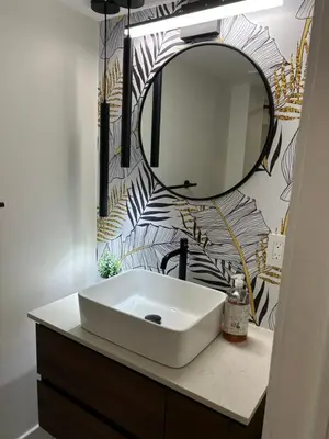 a bathroom with a sink and a mirror at Luxurious modern basement apartment in Pickering