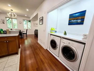 a kitchen and living room with a washer and dryer at Harbour for rest in Vaughan
