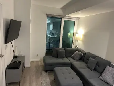 a living room with a couch and a tv at The Evergreen Shelter in Vaughan