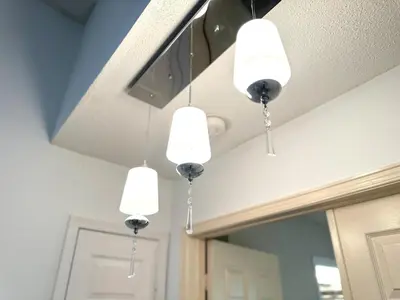a group of lights hanging from a ceiling at Cozy and spacious vacation home in Toronto in Toronto