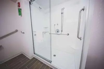a shower with a glass door in a bathroom at Hampton Inn & Suites by Hilton Bolton in Bolton