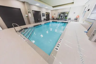 a large swimming pool in a hotel room at Hampton Inn & Suites by Hilton Bolton in Bolton