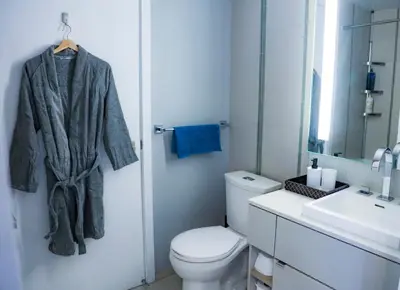 a bathroom with a white toilet and a sink at Stunning suite in downtown perfect for businesses trips and small families in Toronto