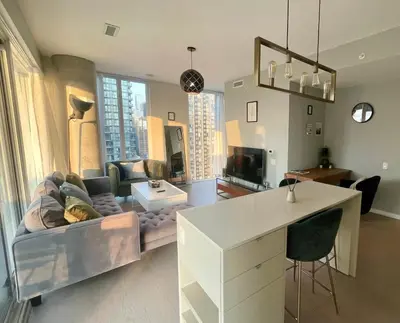 a living room with a couch and a table at Stunning suite in downtown perfect for businesses trips and small families in Toronto